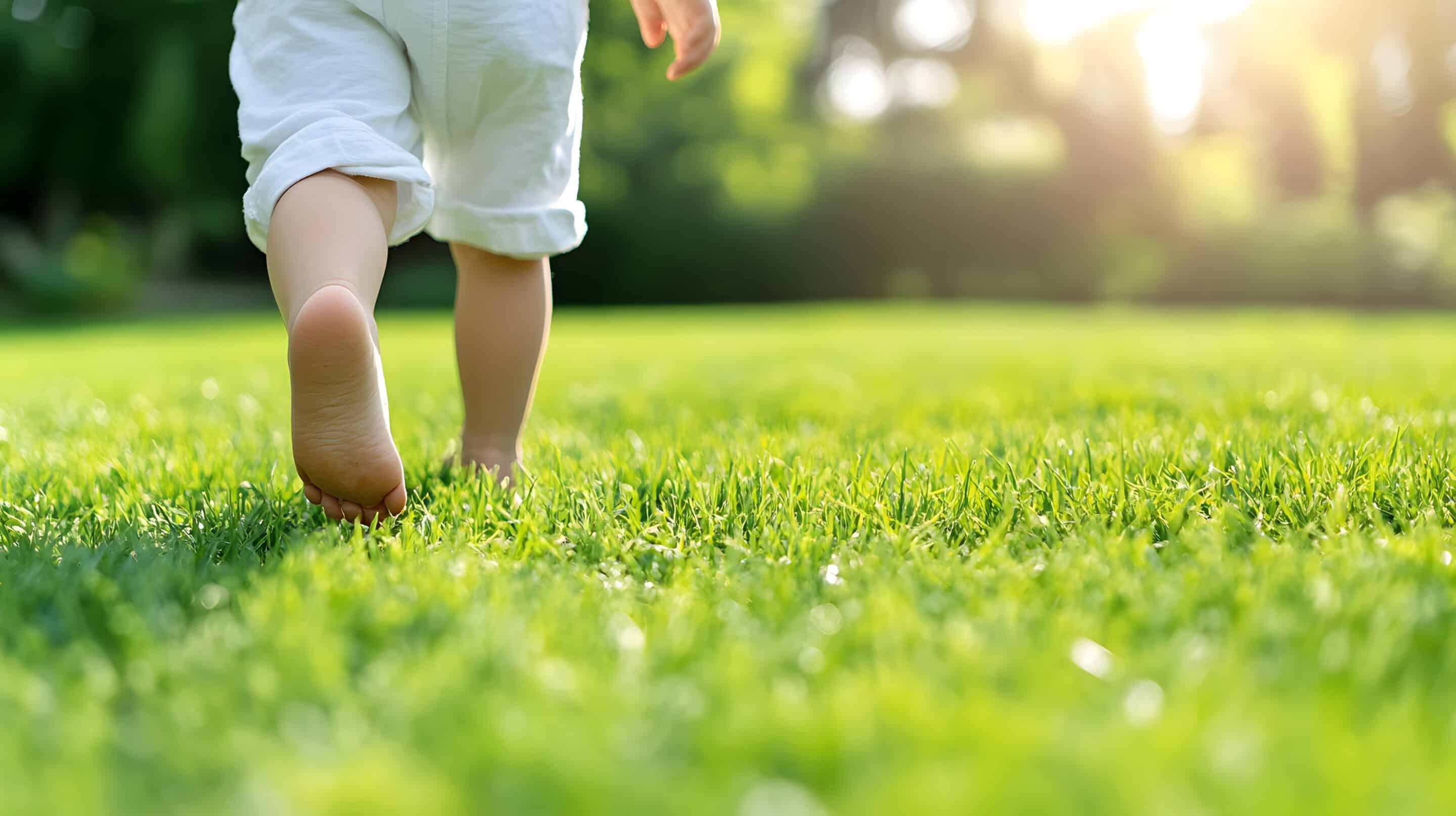 Child walking on lawn.